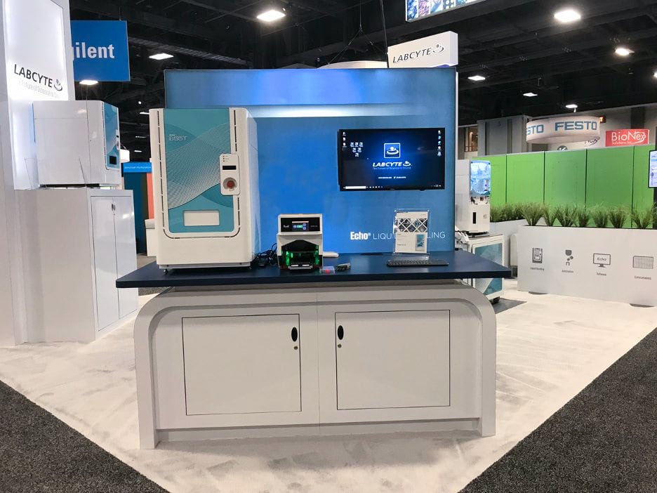 Acoustic sample tube-enabled Echo 655T liquid handling system displayed at a SLAS 2019 trade show booth with Labcyte branding