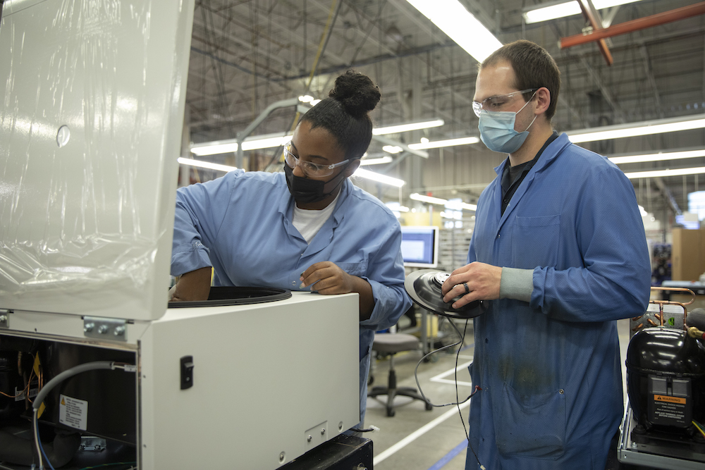 Employees assembling instruments in Beckman factory