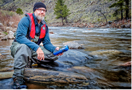 Man with measuring device in river