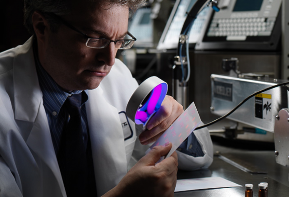 Scientist using a magnifying glass