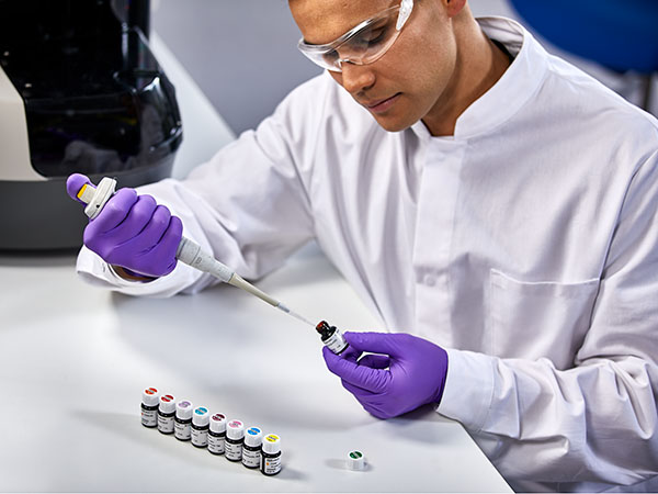 Laboratory scientist pipetting single color antibodies
