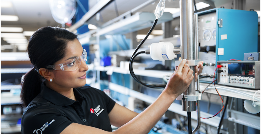 Beckman technician adjusting instrument