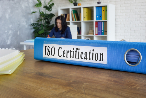ISO certification binder on desk