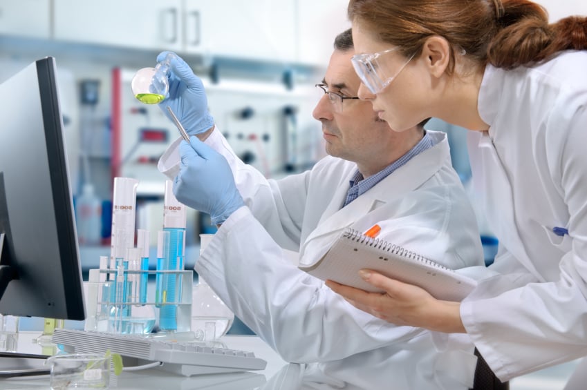 Two scientists in a laboratory examining samples